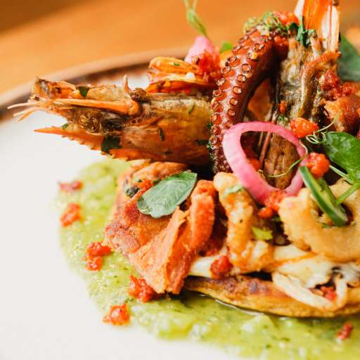 Peri peri tiger prawns on a Tushen private dining table